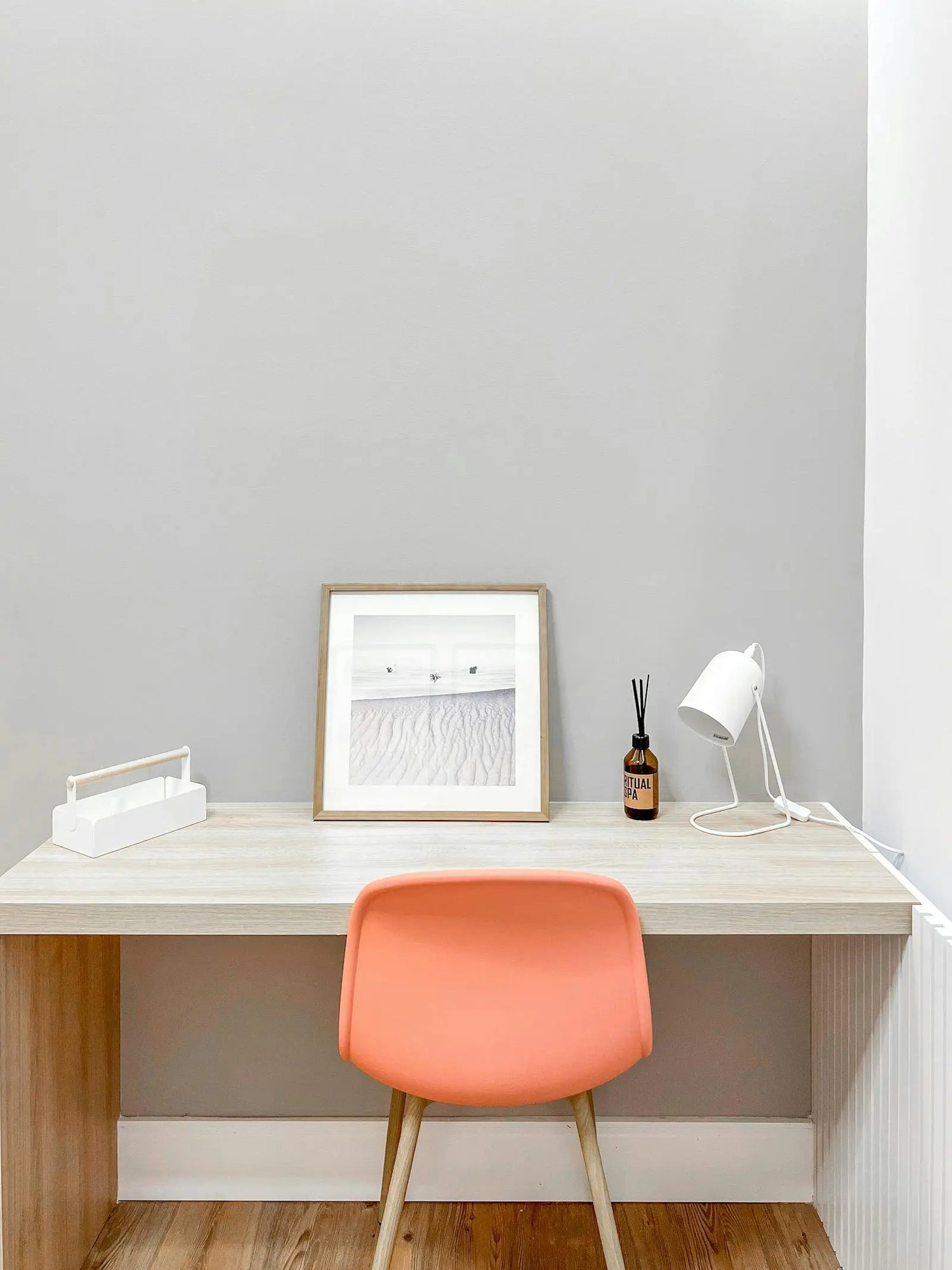 Minimal desk setup with laptop and chair